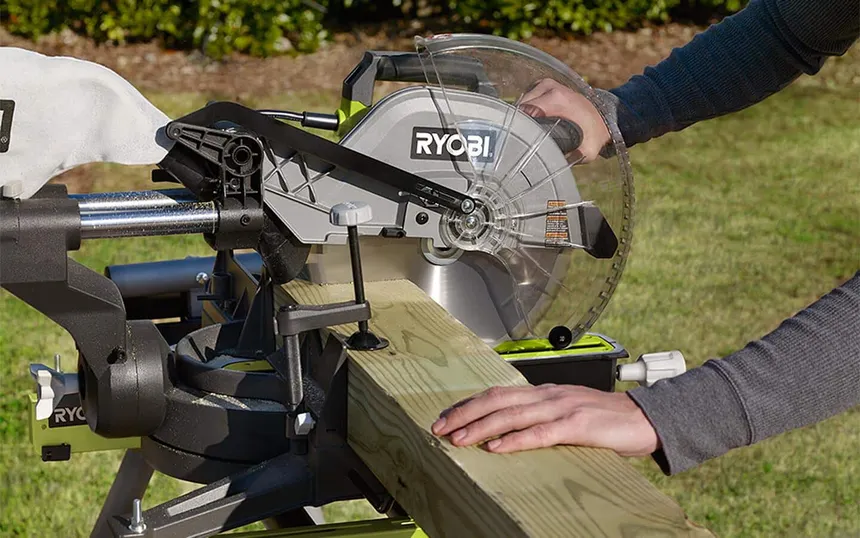 Person using a miter saw to cut wood